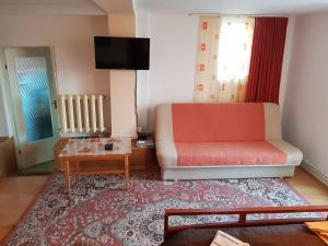 a living room with a couch and a table at MRI Residence in Cluj-Napoca