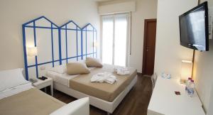 A bed or beds in a room at Mini Hotel