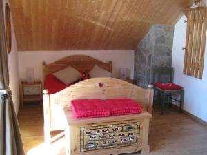 a bedroom with a wooden bed in a room at Le Petit Randonneur in Briançon