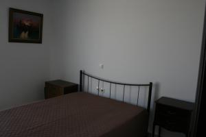 a bedroom with a bed and a picture on the wall at Mousonette in Selínia