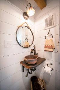 a bathroom with a sink and a mirror at Cozy Cabin Little Red Hen 12 min to Magnolia in Waco