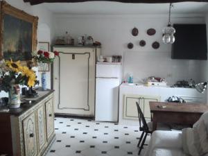 a kitchen with a refrigerator and a table in a room at un'oasi di tranquillità in Genoa