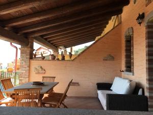 a patio with a table and a couch and chairs at La Stella Marina Tanca Piras in Nebida