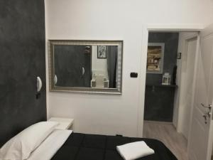 ローマにあるItaly Guest Houseのベッドルーム1室(ベッド1台、鏡、バスルーム付)