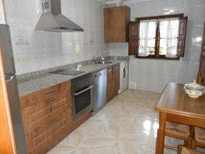 a kitchen with a sink and a stove at La Bolerina in Celorio