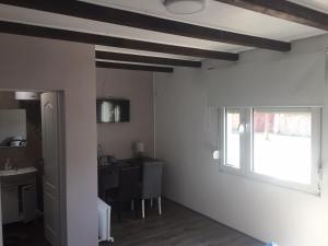 a living room with a table and a window at Alex Lodge in Zrenjanin