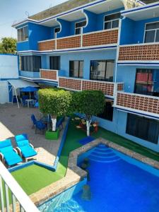 un edificio azul con una piscina frente a él en Casa de Huéspedes May, en Ixtapan de la Sal 14 fotos más