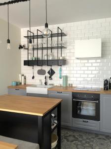 a kitchen with a sink and a table in it at Blue Sea Apartment in Międzyzdroje