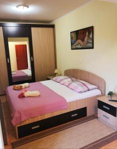 a bedroom with two beds and a large mirror at Apartman Roza in Ploče