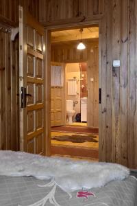 a bedroom with a door open to a bathroom at Na ubocy in Brzegi