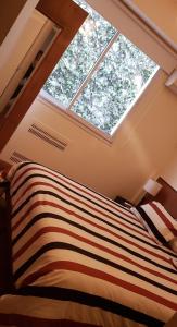 a bedroom with a bed with a large window at Confortable 2 ambientes en Recoleta Excelente Ubicacion in Buenos Aires