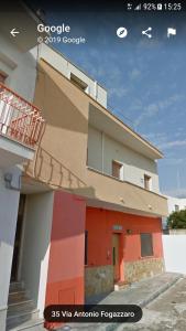 a building with a staircase on the side of it at Relax appartamento in Porto Cesareo