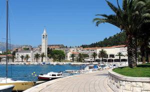 a marina with boats in the water and a city at Apartman Roza in Ploče