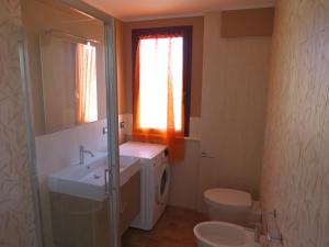 a bathroom with a sink and a toilet and a window at La casa de Rocche in Cupra Marittima +17 photos