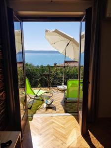 a view of a patio with an umbrella and chairs at Apartma Kočevar Portorož in Portorož