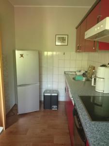 a kitchen with a white refrigerator and a sink at Ferienwohnung Knoche in Zittau