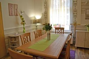 a dining room with a wooden table and chairs at Pension zur Neiße in Guben