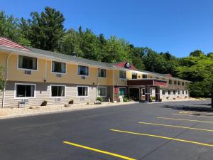 an empty parking lot in front of a building at Days Inn & Suites by Wyndham Stevens Point in Stevens Point