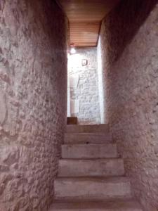 a staircase in a brick building with a stair case at Villa Athéna,séjour bien-être et éthique in Meuvaines