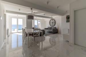 a dining room and living room with a table and chairs at The View Residence in Crikvenica