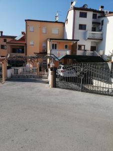 ein Tor vor einem Gebäude mit einem Zaun in der Unterkunft Apartment Zdravko in Štinjan