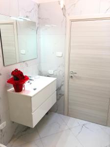 a white bathroom with a sink and a mirror at Residenza San Rocco in Arco +42 photos