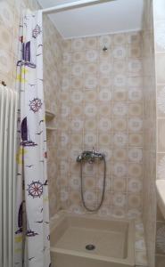 a bathroom with a tub and a shower curtain at Villa Christie in Keramoti +25 photos