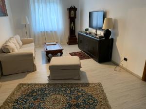 a living room with a couch and a tv at Residence San Pietro Book sharing in Nola