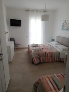 Postel nebo postele na pokoji v ubytování Via della Salvia + 1 fotografie
