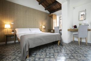 a bedroom with a bed and a table and chairs at Bed in Spa in Palermo +22 photos