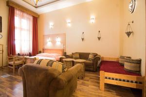a living room with two couches and a table and a couch at Budapest Royal Suites in Budapest