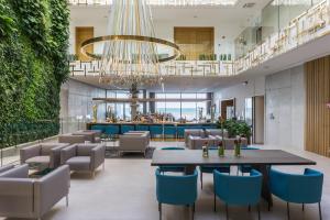 a lobby with a table and chairs and a bar at Posia Retreat & Spa UNA Esperienze in San Foca