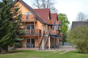 a building with wooden staircases on the side of it at Appartement Dachgeschoss in Schlepzig