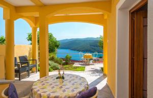 a patio with a table and a view of the water at Apartments Gracia - with great view in Rabac