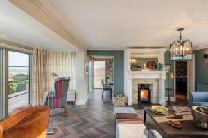 a living room with a couch and a fireplace at Beam Ends in Beesands