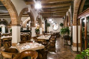 a restaurant with tables and chairs in a room at Imperio De Angeles in San Miguel de Allende