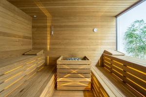 a sauna with two benches and a window at Posia Retreat & Spa UNA Esperienze in San Foca