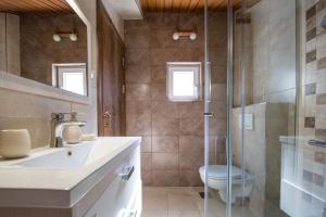 a bathroom with a shower and a sink and a toilet at Apartments Villa Jovovic in Budva +69 photos
