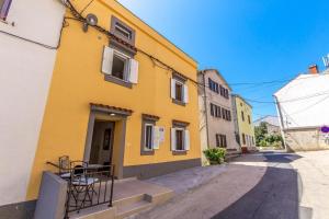 a yellow building on a street at Apartment in Vrbnik/Insel Krk 36845 in Vrbnik
