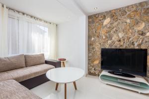 a living room with a couch and a flat screen tv at Apartment in Vrbnik/Insel Krk 36845 in Vrbnik