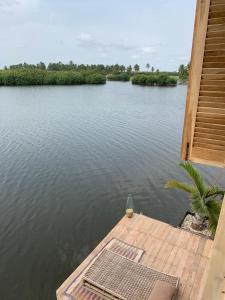 a view of a body of water with a dock at Natura luxury lodge in Ouidah