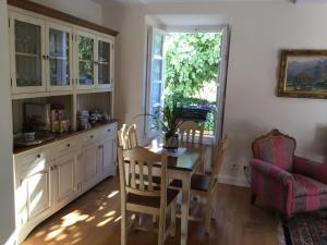 a kitchen with a table and chairs and a window at Villa Elena in Potes