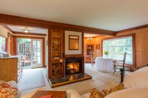 a living room with a fireplace and a table at SCP Mendocino Inn and Farm in Little River