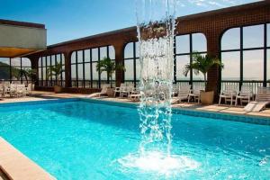 a fountain in the middle of a swimming pool at Residencial Pasárgada, apto 602 in Vila Velha