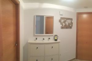 a bathroom with a sink and a mirror at Apartamento Ahola in Archena +29 photos