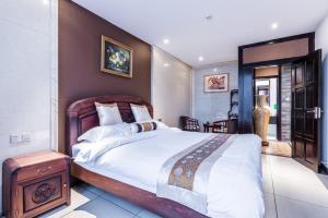 Postel nebo postele na pokoji v ubytování Hainan Jingshan Hotel