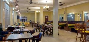 a restaurant with wooden tables and chairs and tables and tablesktop at Jelly's Haven Resort in Bantayan Island