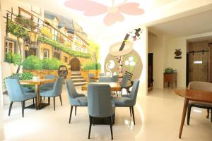 a restaurant with a table and chairs and a wall mural at MUSHROOM30 in Taitung City