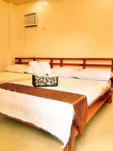 Säng eller sängar i ett rum på Damara Beachfront Resort