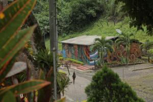 a person walking in front of a building with a mural at HOTEL LA SELVA Reserva in La Vega